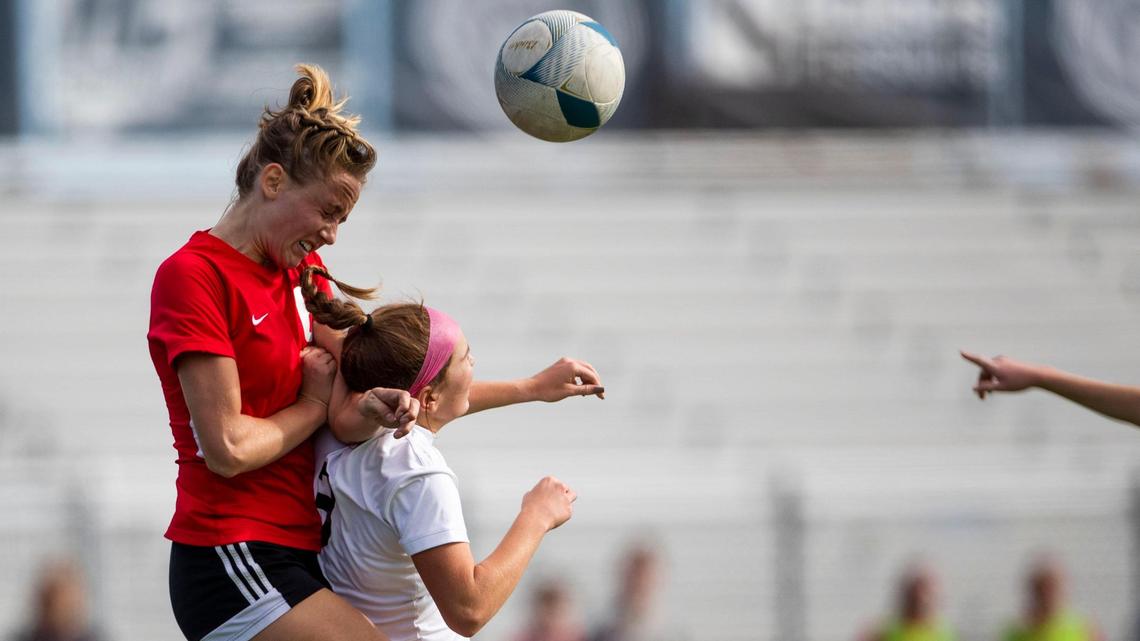 Boise defender Emma Zelinsky reaches for a header over Eagle’s Emily Houck on Thursday in the first round of the 5A girls soccer state tournament. Zelinsky was whistled for a foul on the play, but Boise advanced in the tournament with a 2-1 win.