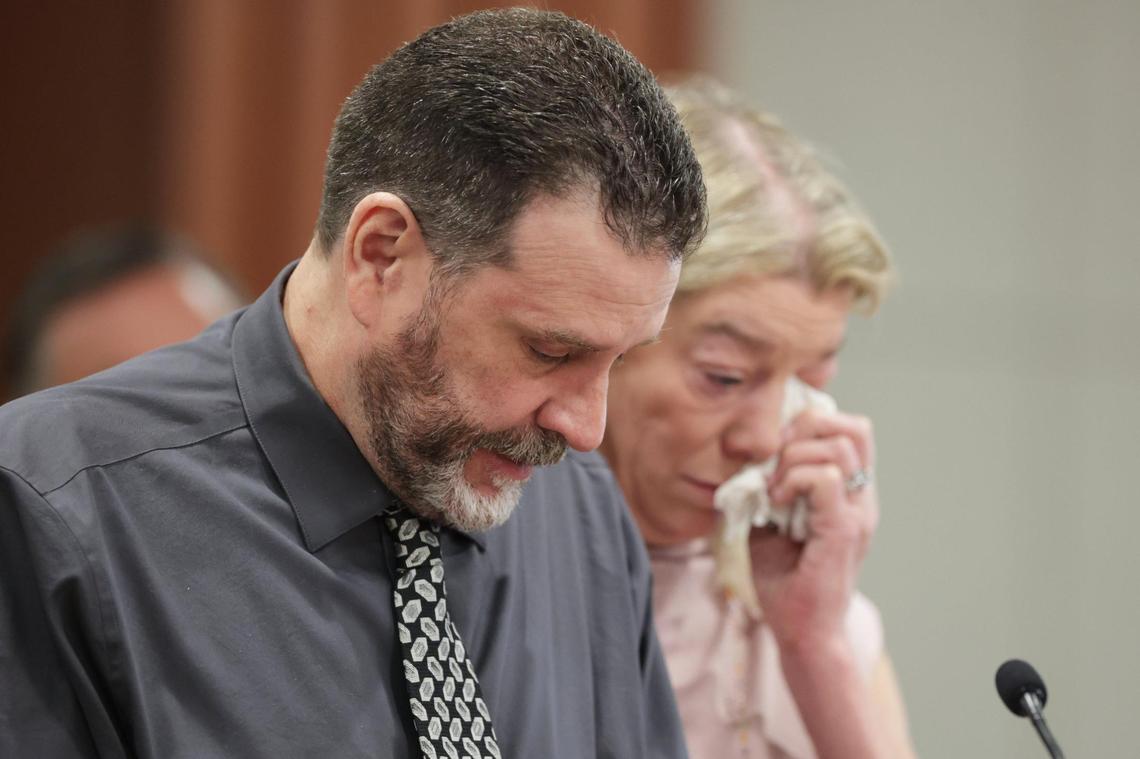 Scott Laramie, left, stepfather of University of Idaho student murder victim Madison Mogen, speaks at the sentencing hearing of Bryan Kohberger as his wife and Mogen’s mother, Karen Laramie, wipes her eyes.
