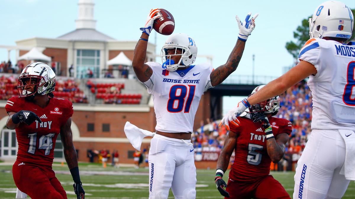 Boise State wide receiver Akilian Butler (81) celebrates after catching a pass for a touchdown over Troy cornerback Terence Dunlap (14) and safety Cedarius Rookard (5).
