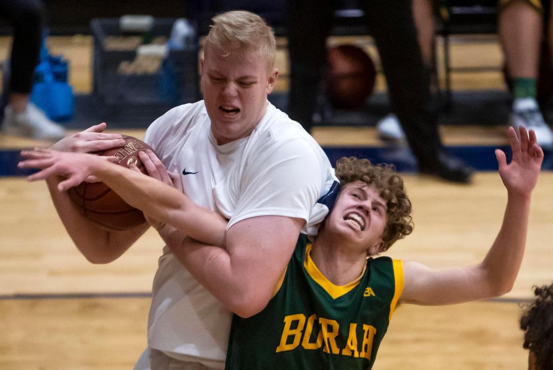 Meridian junior Brody Rowbury grabs a rebound from Borah’s Luke Hoetker during a Jan. 31 game at Meridian High School.