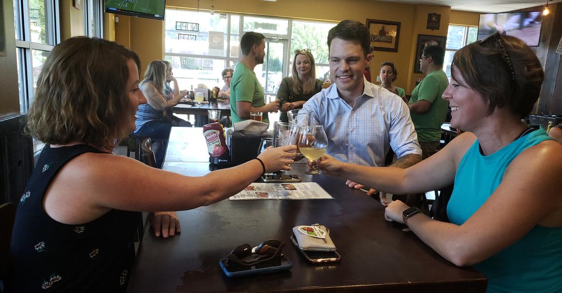 Alysha Prisbrey, left, and Brandee Devine, live close enough to walk to CopenRoss Growlers and other businesses in the Hillcrest Shopping Center. They share a toast with Patrick Bageant, a Boise lawyer who is running for the City Council. Prisbrey and Devine said they’d like to see a coffee shop and other small businesses come to their neighborhood.