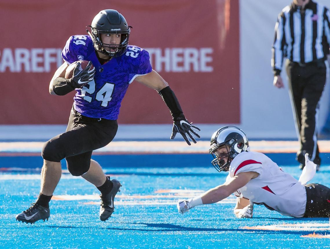 Rocky Mountain running back Nick Romano cuts up field after beating Highland corner Carter Fellows around the edge during the 5A state football championship Saturday, Nov. 17, 2018 at Albertsons Stadium in Boise.