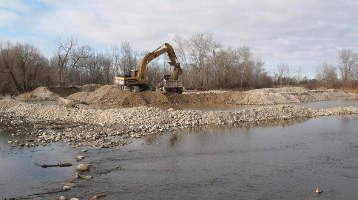 Workers remove gravel at Eagle Island.