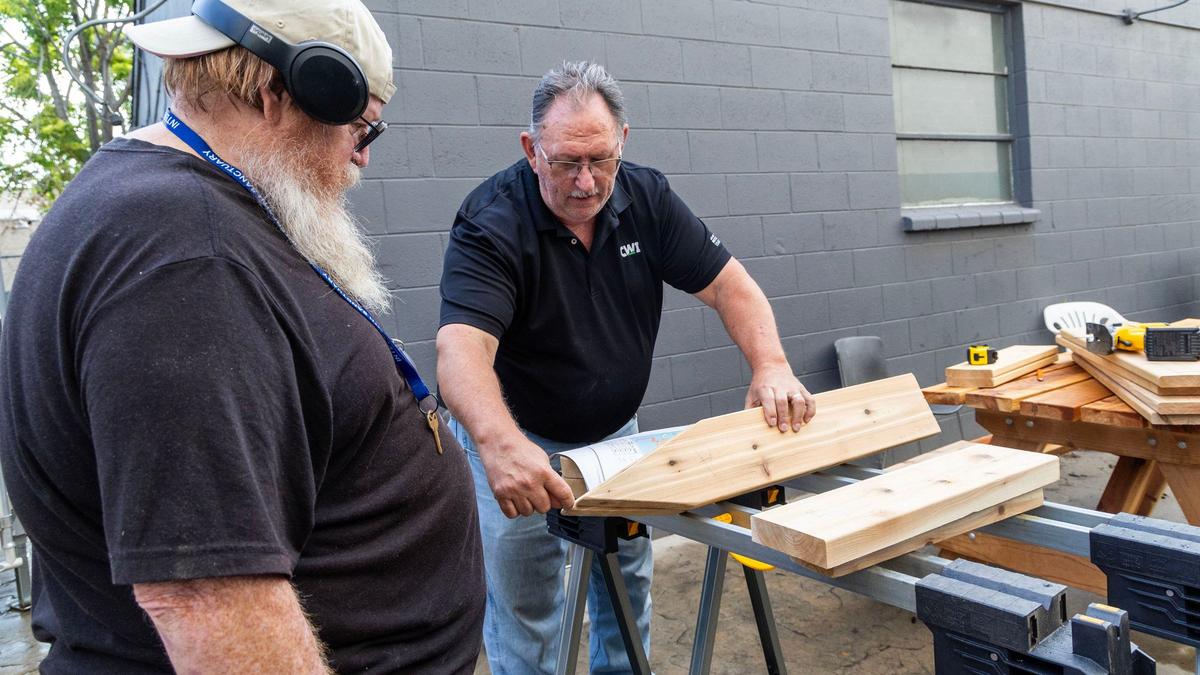 Justin Tominson, left, listens as CWI instructor Ronald Alexander gives pointers on how to build an Adirondack chair.