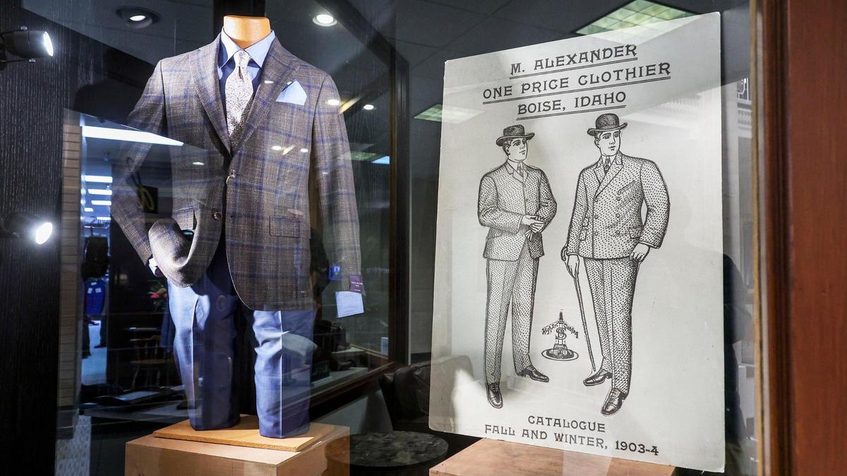 Kevin Hadway, a sales representative at Alexander Davis Men’s Clothing in downtown Boise, measures the fit of a pair of pants for customer Nate Isaak.