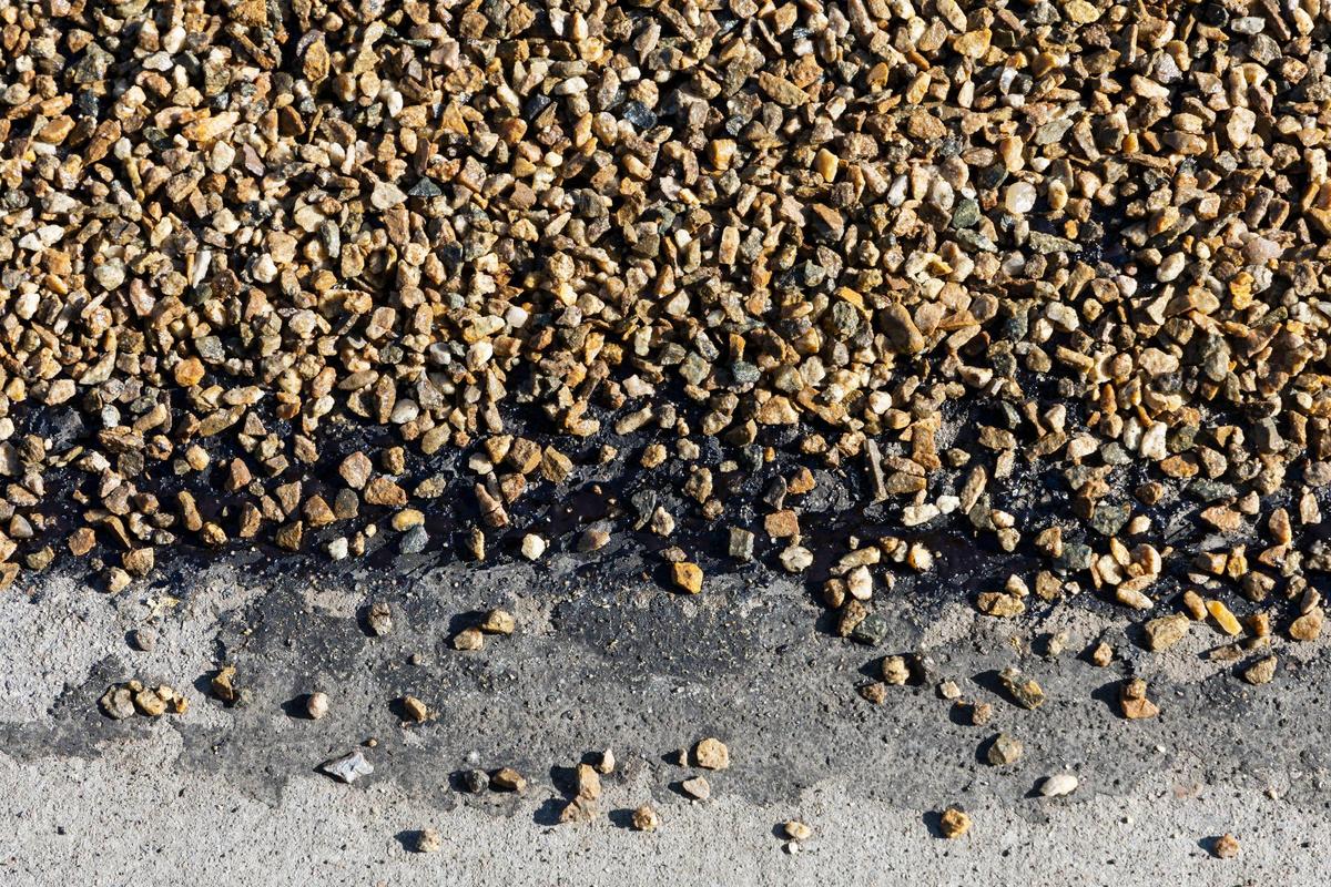 A layer of fresh oil followed up with chipped rock, or seal coating, gives new life to roads.