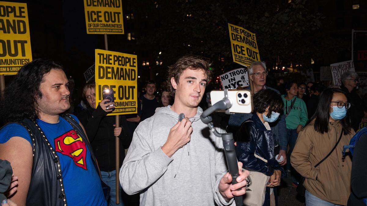 NEW YORK, NEW YORK - OCTOBER 22: Conservative influencer Nick Shirley films protestors demonstrating against U.S. Immigration and Customs Enforcement (ICE) arrests on October 22, 2025 in New York City. Federal agents arrested nine individuals during an operation on Manhattan's Canal Street on Tuesday, targeting undocumented immigrants potentially linked to illegal street vending, according to officials and a senior law enforcement source familiar with the investigation. (Photo by Adam Gray/Getty Images)