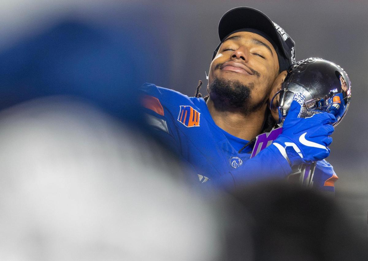 Boise State wide receiver Latrell Caples holds the trophy after Boise State’s win in the Mountain West championship game against UNLV, Friday, Dec. 6, 2024 at Albertsons Stadium.