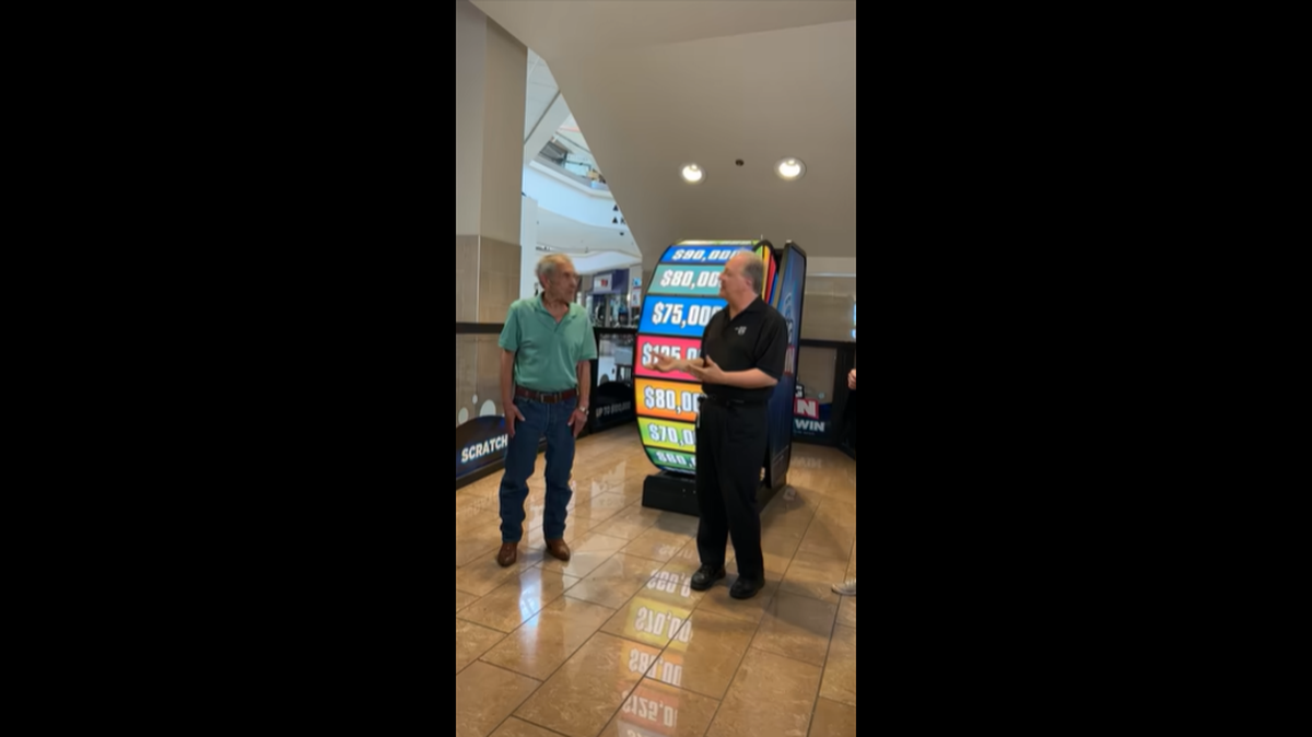 Dennis Bell, left, won a big prize after playing The Big Spin game in Boise, Idaho Lottery officials said.