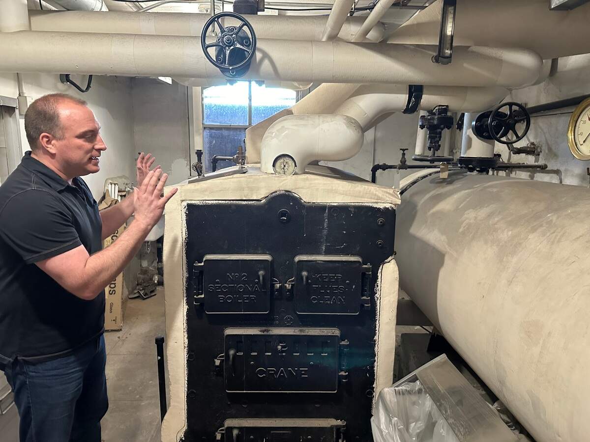 Dan Everhart, Idaho State Historic Preservation Office outreach historian, explains the old coal-fired boiler system installed in the basement of the Assay Office in Boise by the U.S. Forest Service when it took over the building in 1932. The building is now connected to the city’s geothermal system, but the boiler remains.