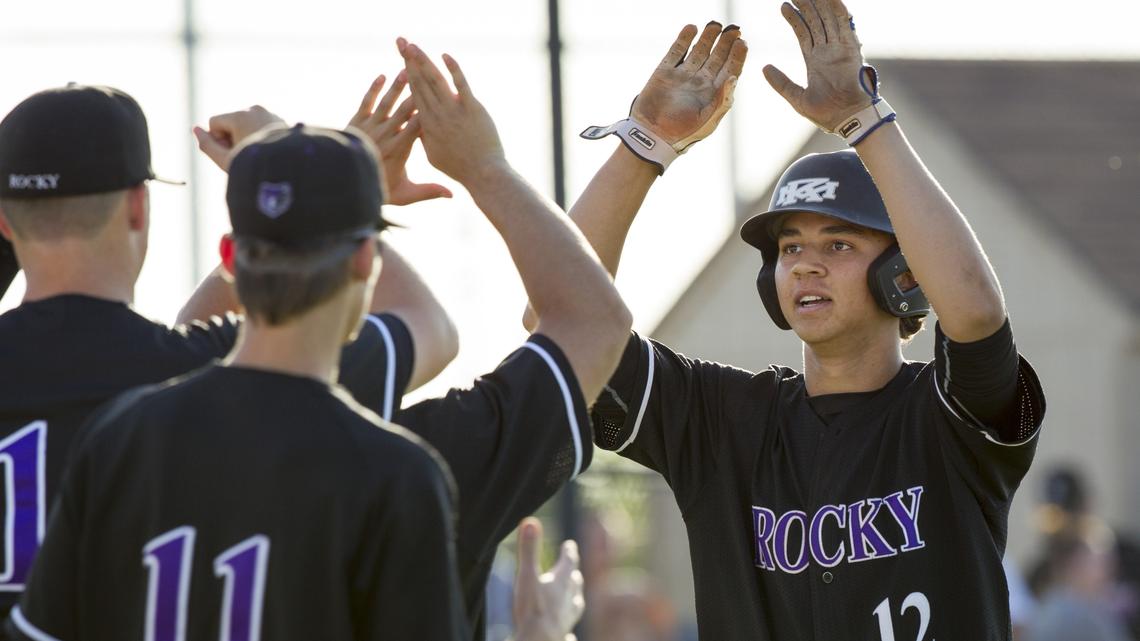Rocky Mountain's Gabe Hughes celebrates with his teammates after a solo home run in Game 2 of the 5A District 3 championship baseball series at Mountain View High.