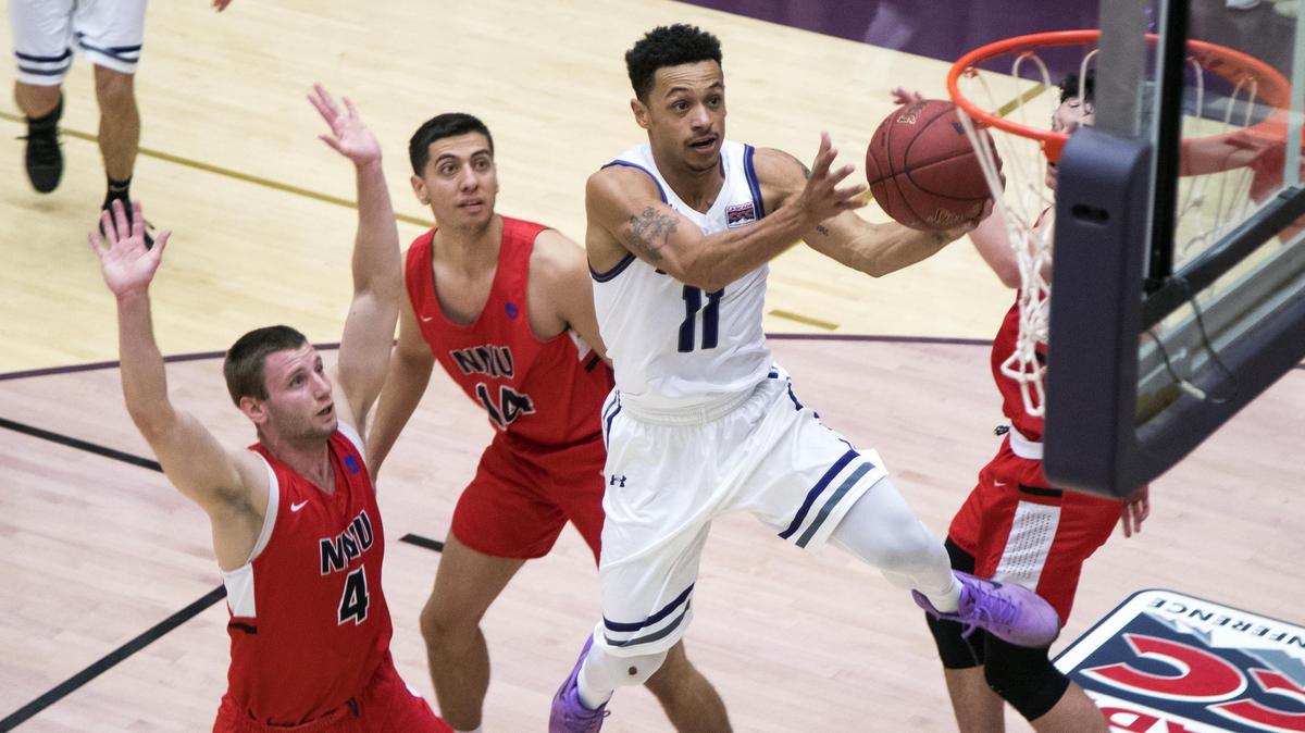 College of Idaho point guard Talon Pinckney drives through Northwest Nazarene’s defense during the United Heritage Mayors’ Cup in Caldwell. The Yotes won 86-82 in double overtime.