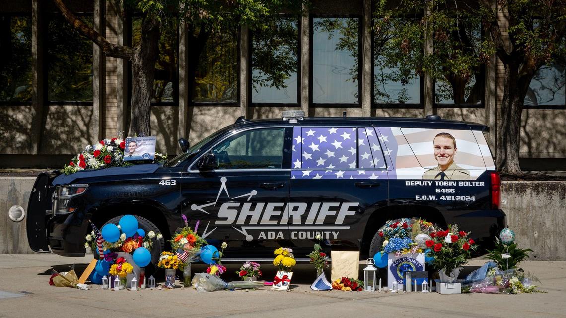 A temporary memorial for Ada County Sheriff’s Deputy Tobin Bolter, who was killed in the line of duty, stands in front of the agency offices on Barrister Road in Boise. Bolter’s patrol vehicle is surrounded by flowers, cards and tokens of appreciation.