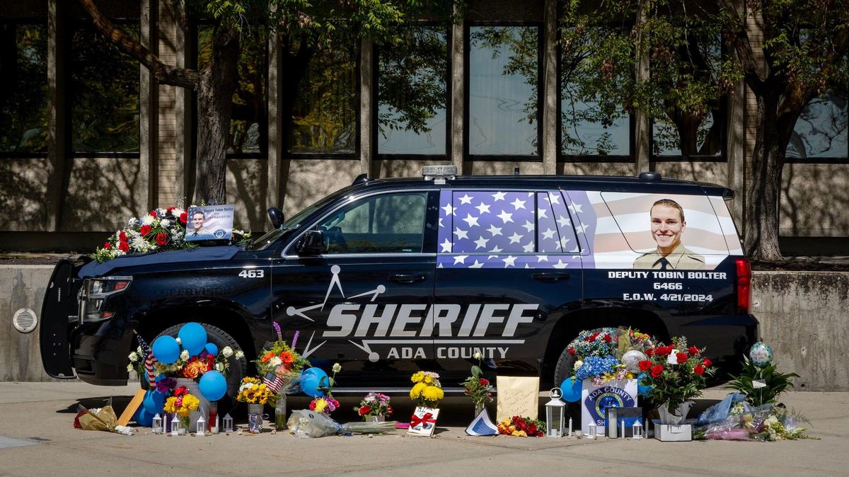 A temporary memorial for Ada County Sheriff’s Deputy Tobin Bolter, who was killed in the line of duty, stands in front of the agency offices on Barrister Road in Boise. Deputy Bolter’s patrol vechicle is surrounded by flowers, cards and tokens of appreciation for his service to the community.