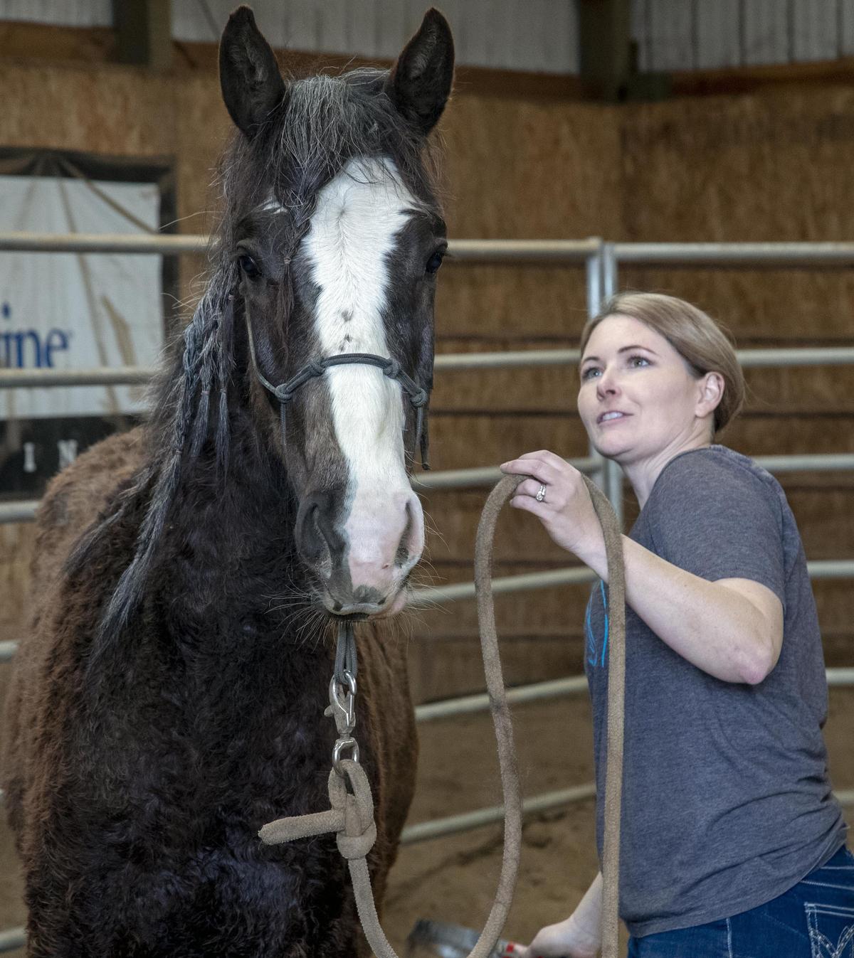 Jamece Vincent watches for signs that her mustang Stormy is getting comfortable with the feeling of a string repeatedly touching her legs and back during training in Caldwell. Stormy was adopted through the BLM’s wild horse and burro program.