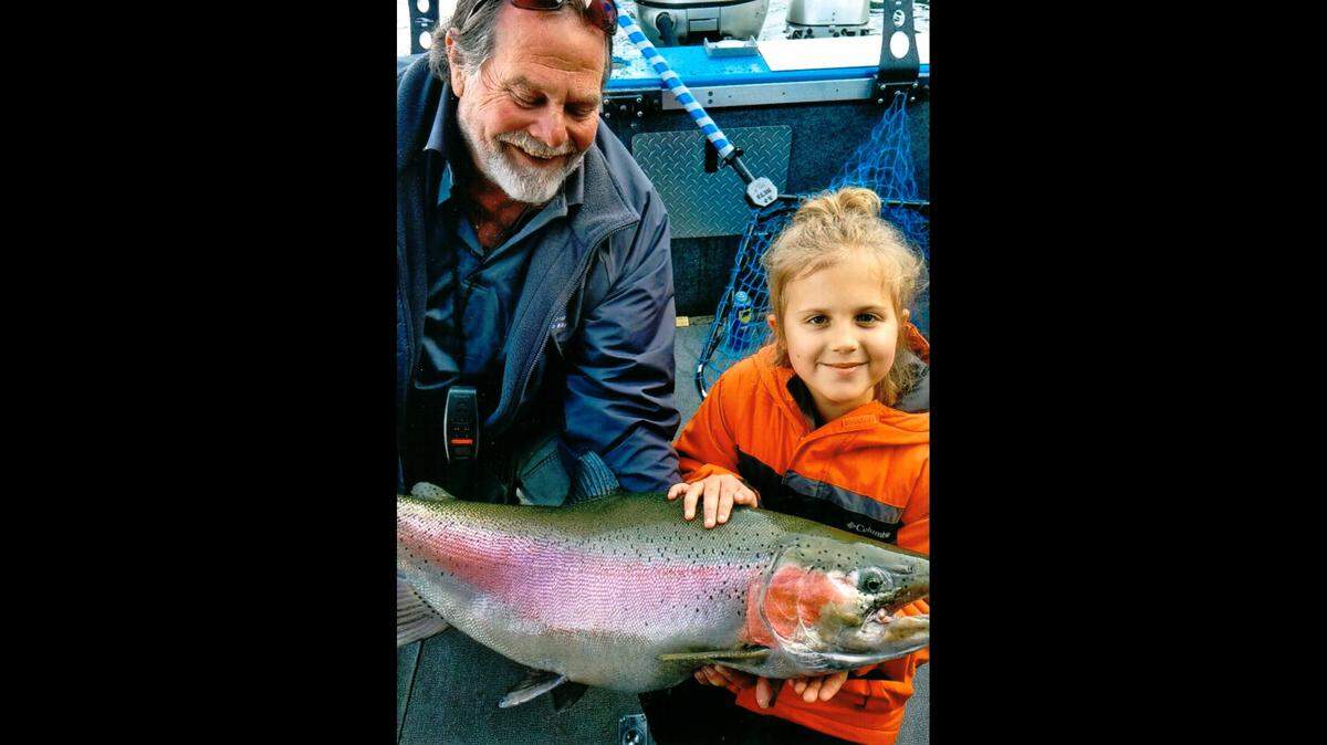 Sophie Egizi, 8, of Sandpoint, Idaho, poses with her catch-and-release record-breaking Gerrard rainbow trout on Oct. 11, 2019. Egizi, who’s joined by Capt. Bob Wiley of Pend Oreille Charters, named the fish “Old Man Sparkles.”