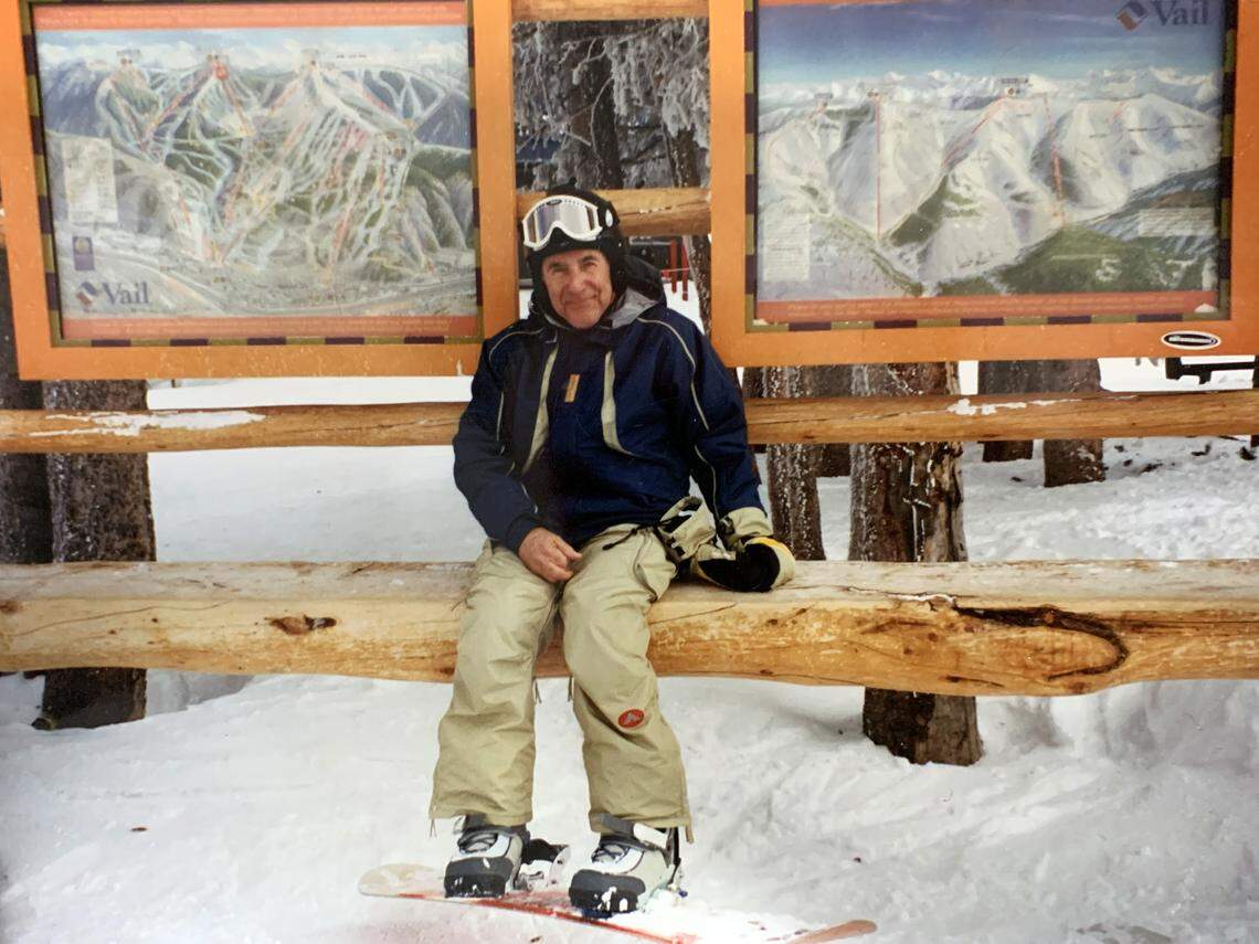 Paul Alden sits outside the Vail Resort in a pair of one of the first step-in snowboard bindings ever invented, by one of his sons, Rick Alden.