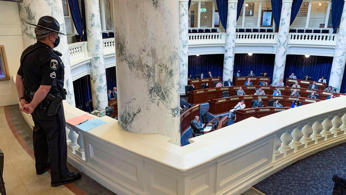 An Idaho State trooper stands guard over the Idaho House of Representatives as they conduct business Wednesday, May 12, 2021 after a one-week recess. The Legislature voted to recess again until September rather than end the session.