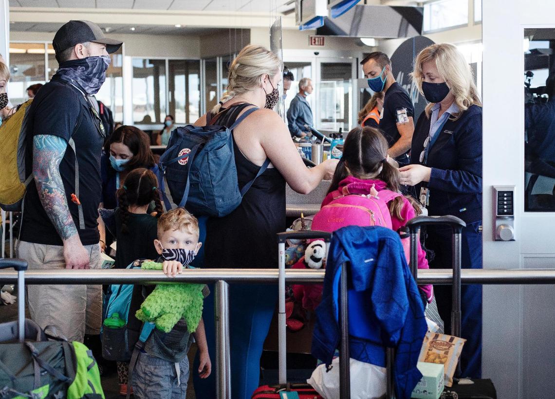 People stand in line to board the inaugural direct flight from Boise to Chicago on Thursday.