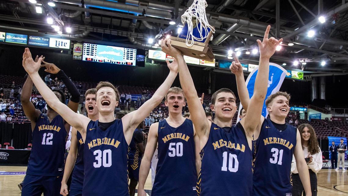 Meridian shares the 5A boys basketball state championship trophy with their fellow students, family and fans after defeating Lake City 68-54 on Saturday at the Ford Idaho Center in Nampa.
