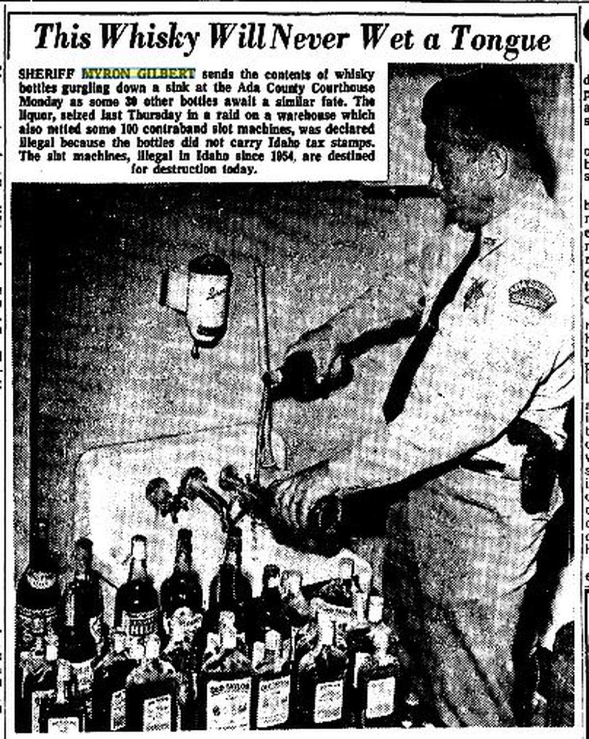 Then-Ada County Sheriff Myron Gilbert pours the contents of 30 bottles of seized whiskey down the drain in July 1964. The liquor was illegal because the bottles lacked Idaho tax stamps.