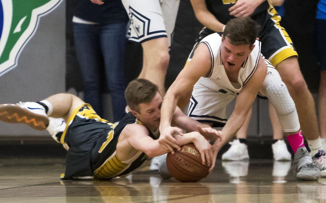 Mountain View guard Dallen Perrin gets tied up with Meridian’s McKay Anderson during the Stinky Sneaker rivalry game Jan. 22 at Mountain View.