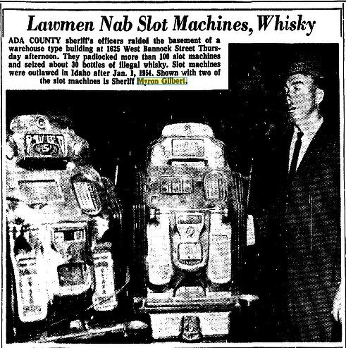Then-Ada County Sheriff Myron Gilbert stands next to two of the 100 slot machines seized from a Boise warehouse in July 1964. The gaming devices had been outlawed in Idaho 10 years earlier.