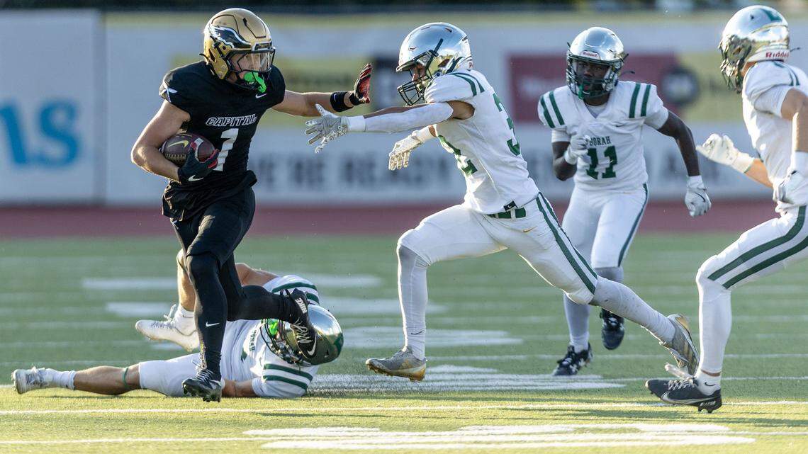 Capital wide receiver Elliot Schrack fends of Borah defenders to gain a first down at Dona Larsen Park in Boise, Friday, Sept. 12, 2025.