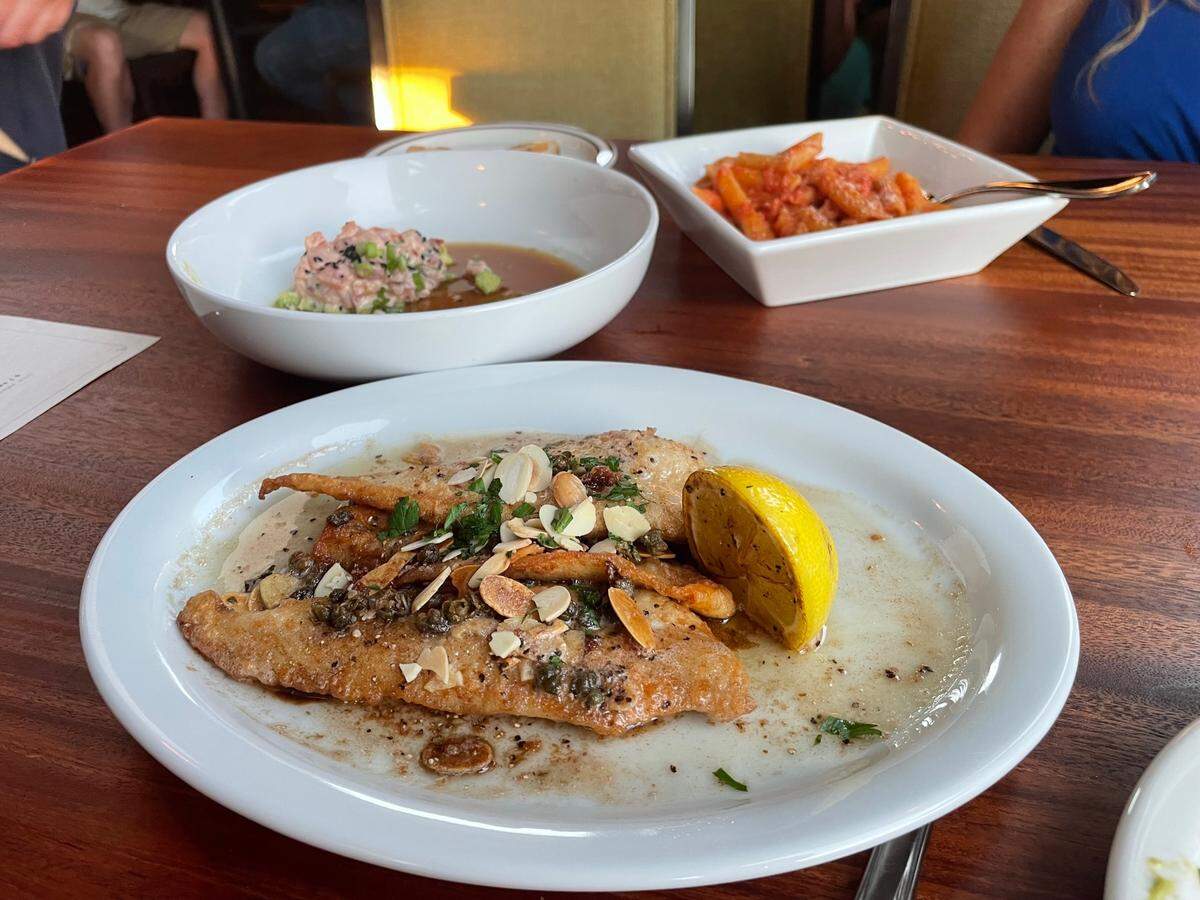 Petrole Sole Almondine, foreground, is one of two seafood entrees. The other, not shown, is Seared Pacific Salmon.