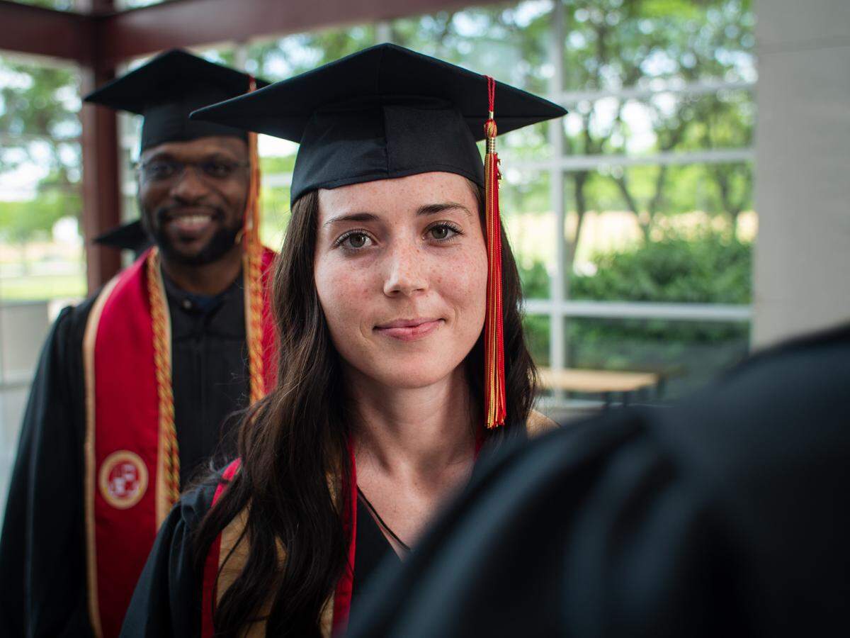 Students graduate from Grantham University, acquired by the University of Arkansas System.