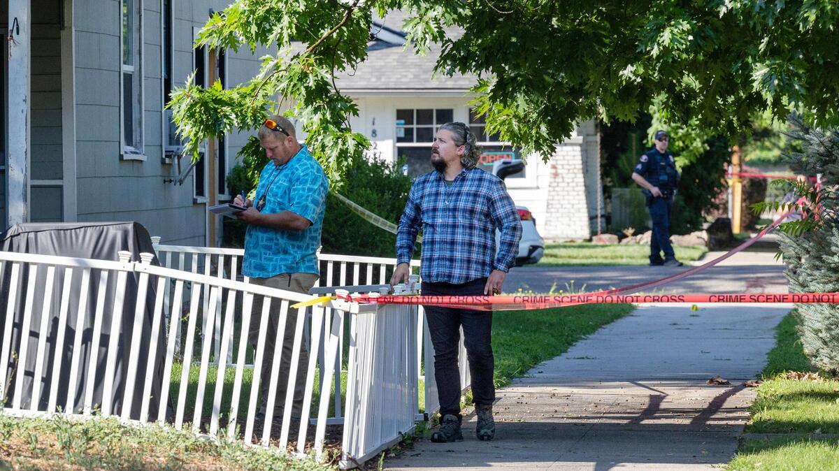 Officials work around the perimeter of a multiblock crime scene Thursday after a fatal shooting Wednesday night near the 700 block of N. 20th St.