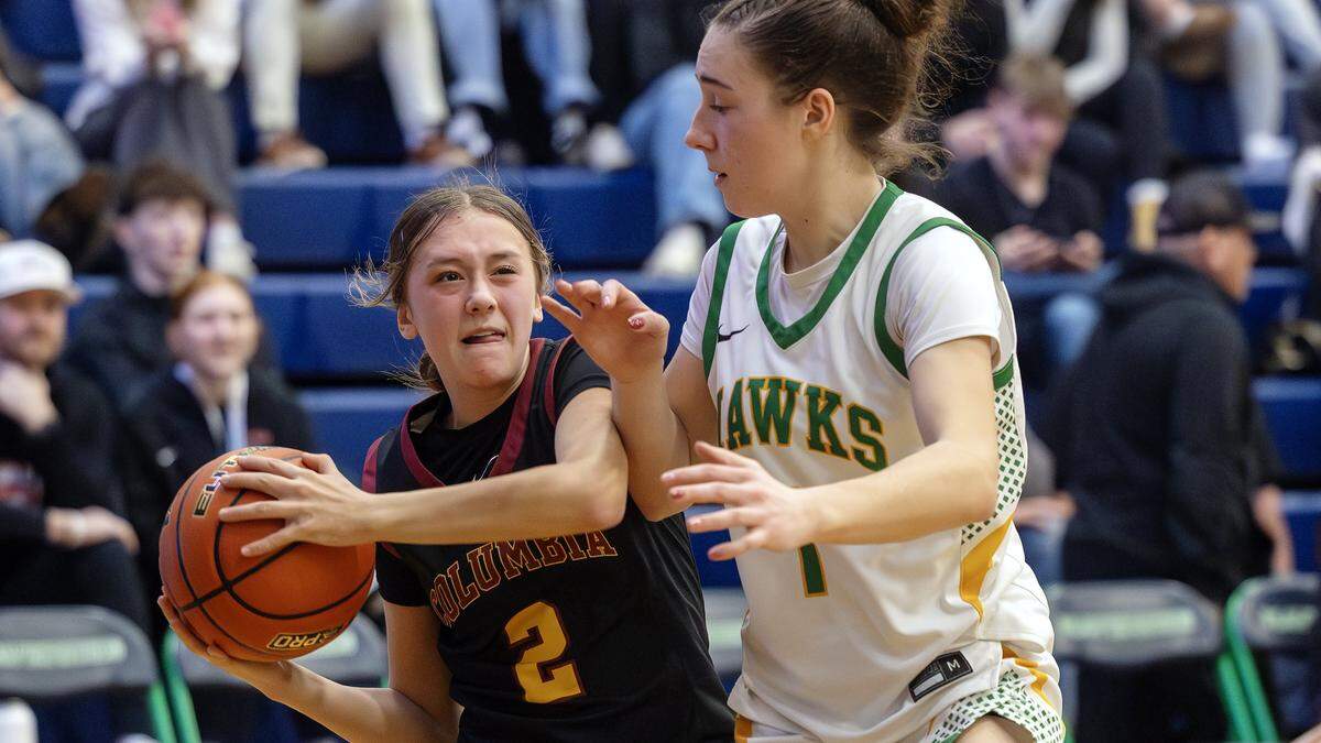 Columbia sophomore Bailey Robertson works her way around Lakeland senior Karstyn Kiefer to score in their matchup in the first round of the 5A girls basketball state tournament at Mountain View High School in Meridian, Thursday, Feb. 19, 2026. Lakeland won 72-28.