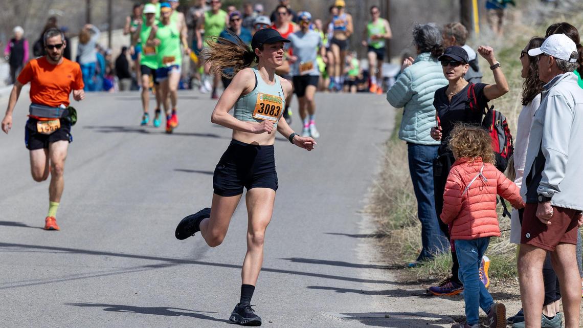 Race to Robie Creek runner Samantha Lewis rounds the corner out of Fort Boise Park on Saturday. Lewis was the first place female finisher.