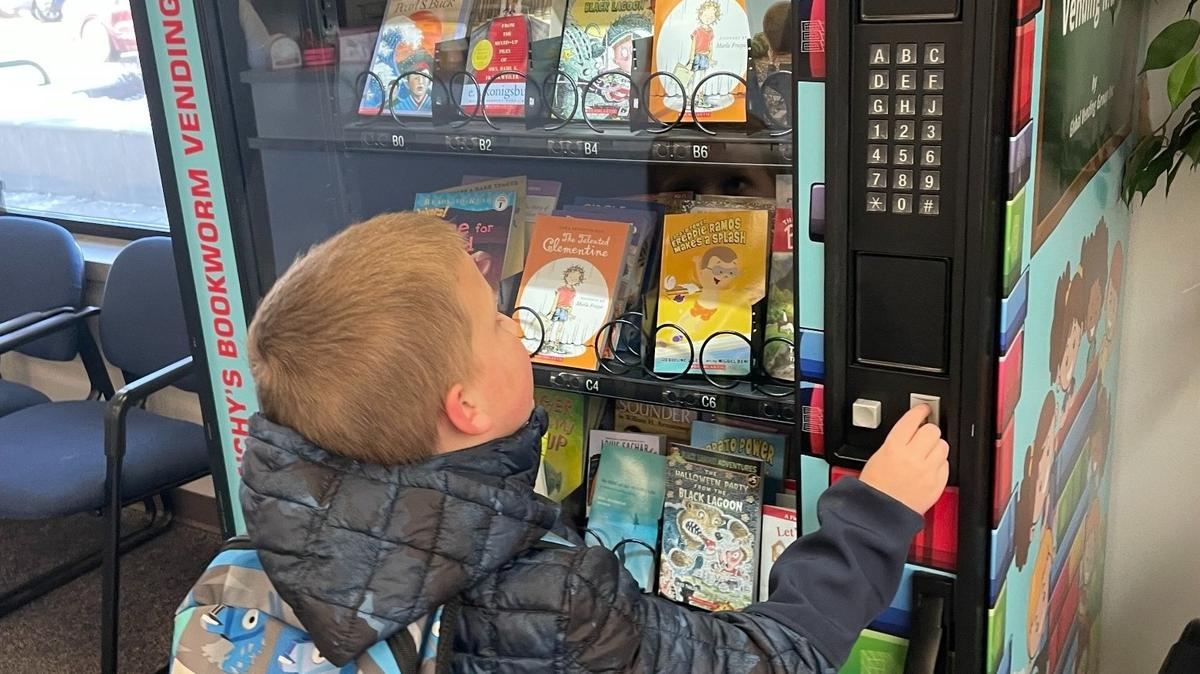 Students can obtain books from the vending machines with gold coins that are rewarded by teachers for good behavior and perseverance in the classroom.