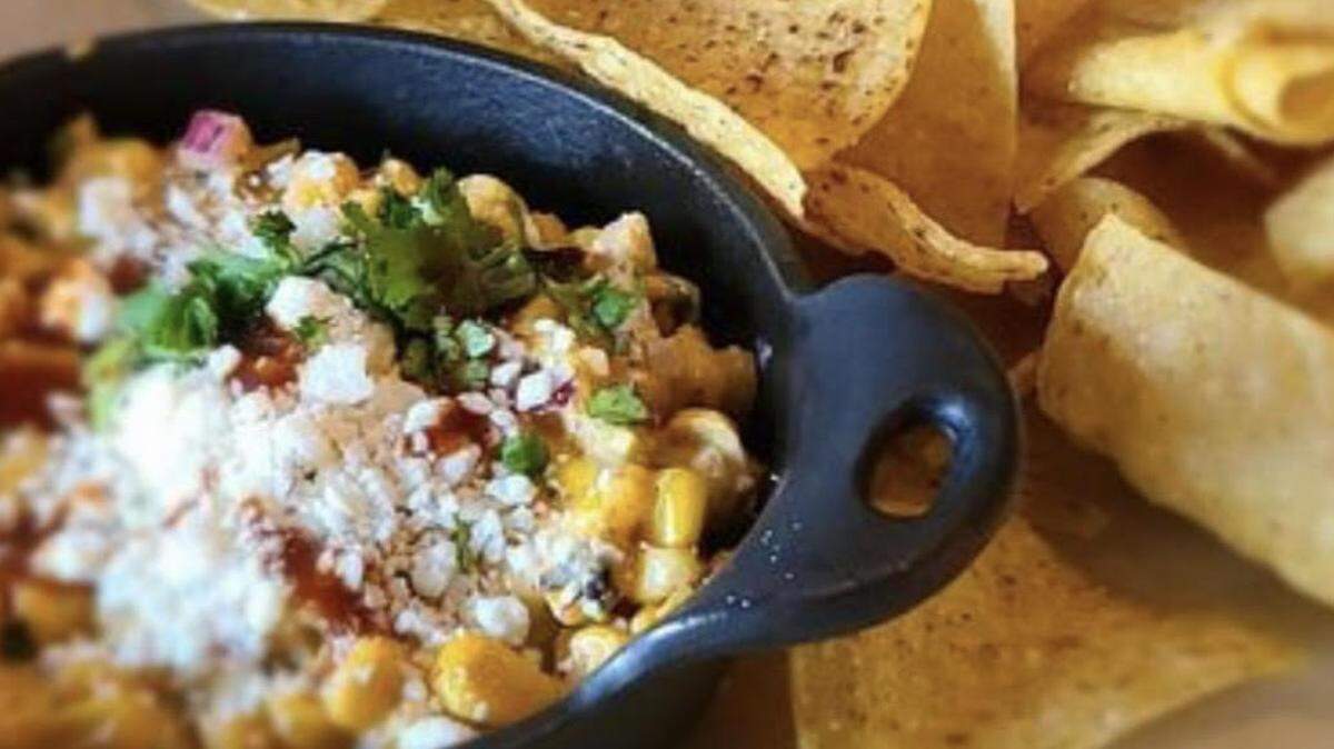 Mexican Street Corn dip is served with chips.