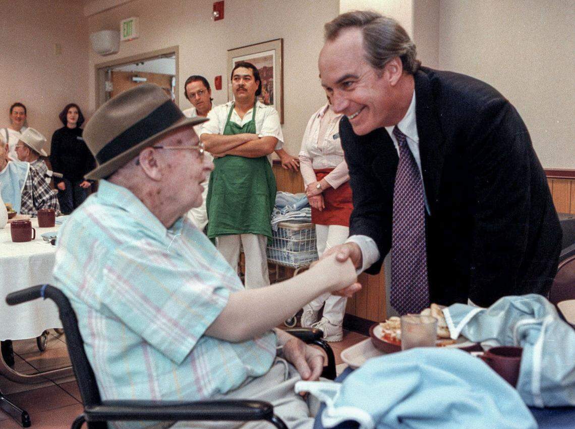 Idaho Gov. Dirk Kempthorne, right, meets James Easley, resident of the Idaho State Veterans Home, before a ceremonial signing of a bill in 2000. The legislation moves the Division of Veterans Services away from the jurisdiction of the Department of Health and Welfare to the Department of Self-Governing Agencies.