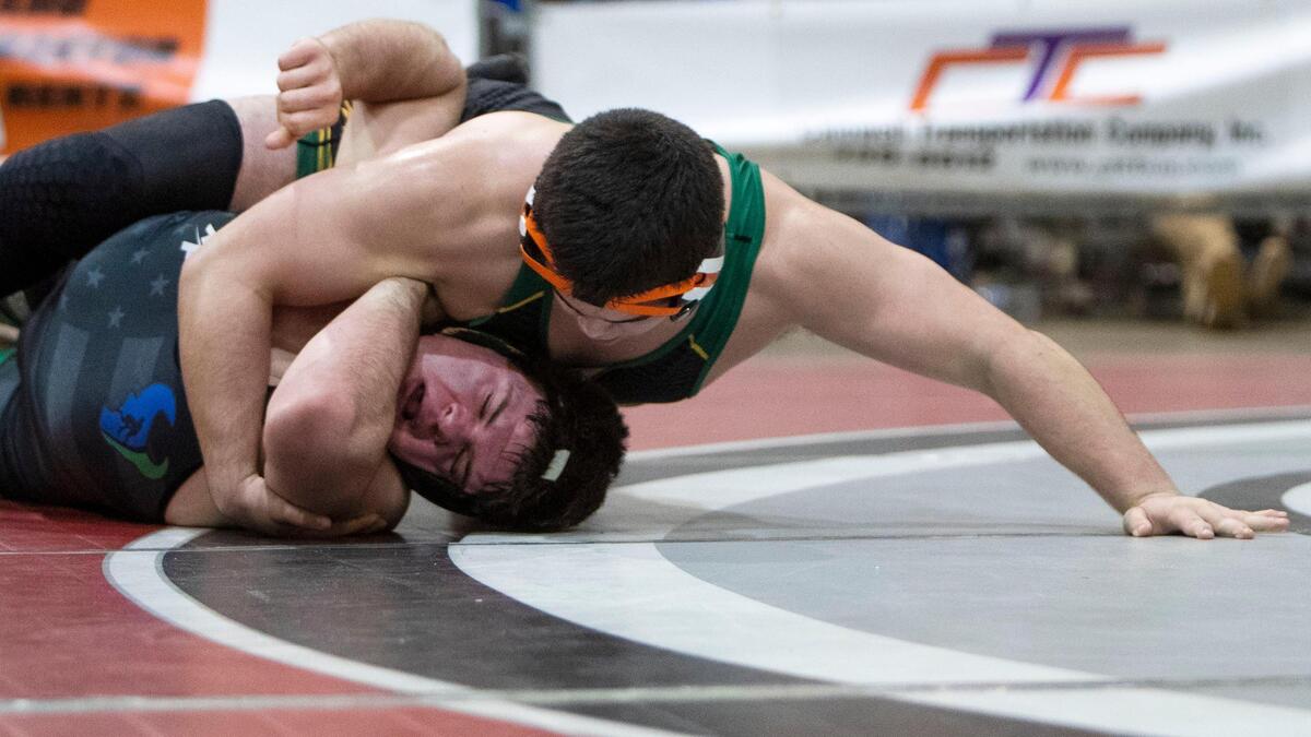 Borah’s Aden Attao pins Mountain View’s Shilo Jones in the heavyweight finals at the 5A District Three wrestling tournament Wednesday.