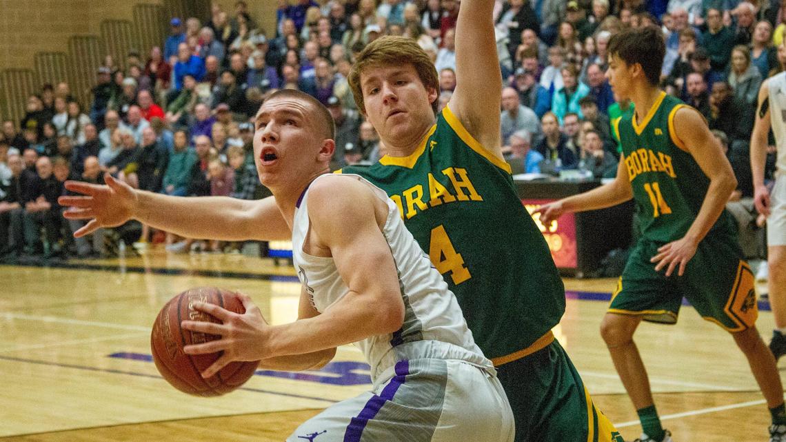 Jaden Hansen, guarded by Borah’s Cameron Pruitt, scored 10 points in Rocky Mountain’s 50-38 win over Borah for the 5A District Three championship Friday.