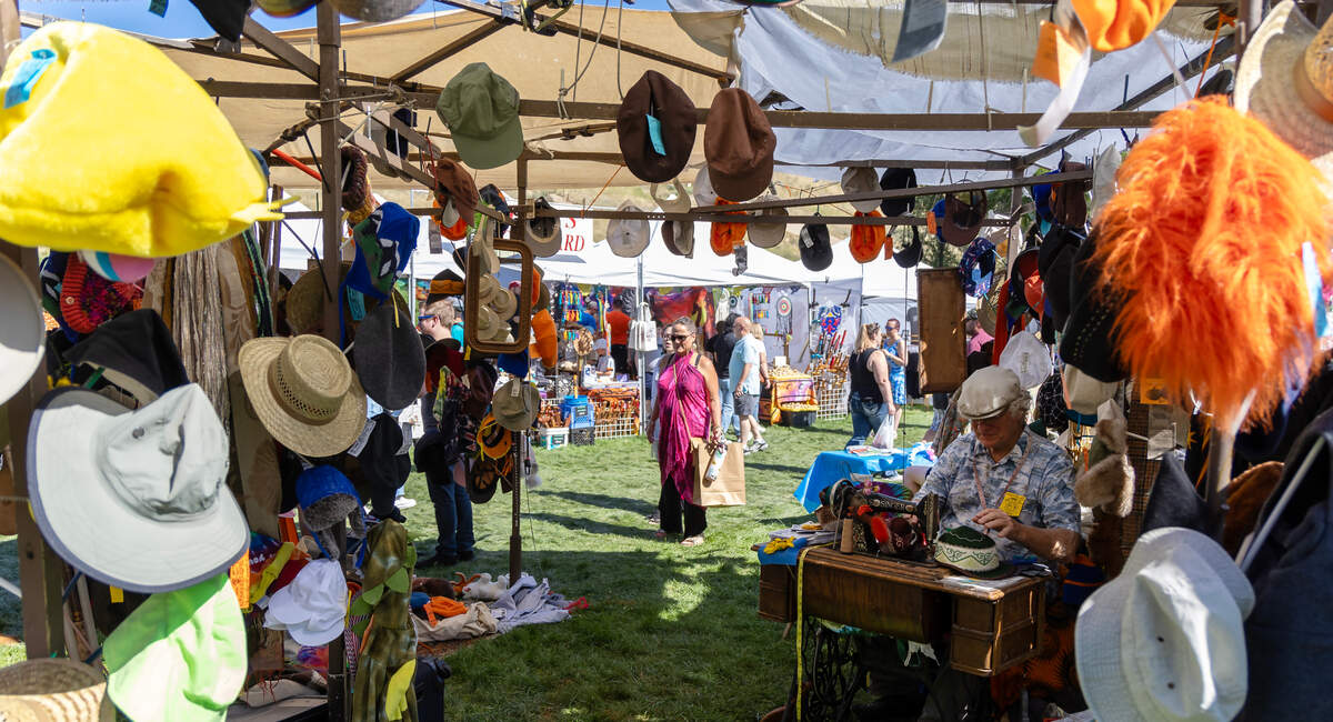 A vendor sells a variety of hats at the Hyde Park Street Fair in 2023.