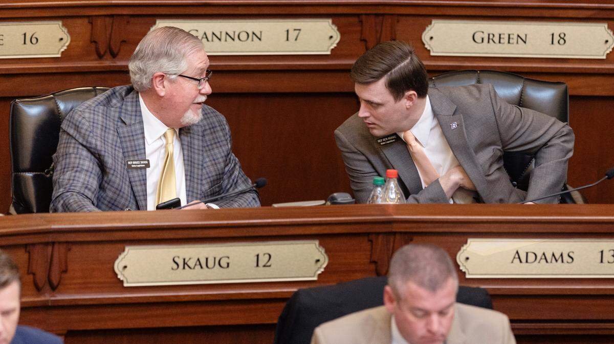 Rep. Bruce D. Skaug, R-Nampa, and Rep. Ben Adams, R-Nampa, talk during the House session on Wednesday, March 16, 2022. Skaug is requiring minors to obtain parental permission to testify in the committee he chairs.