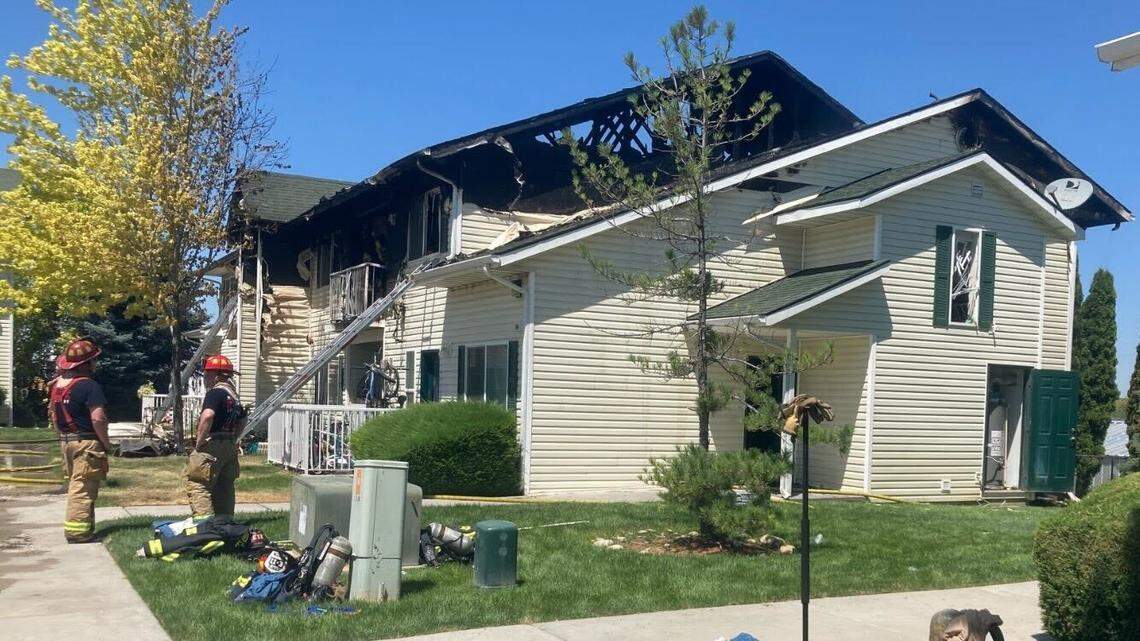 Firefighters outside the Foothills Apartments in Meridian. The complex, located of Franklin Road, left two stories and four units damaged. 