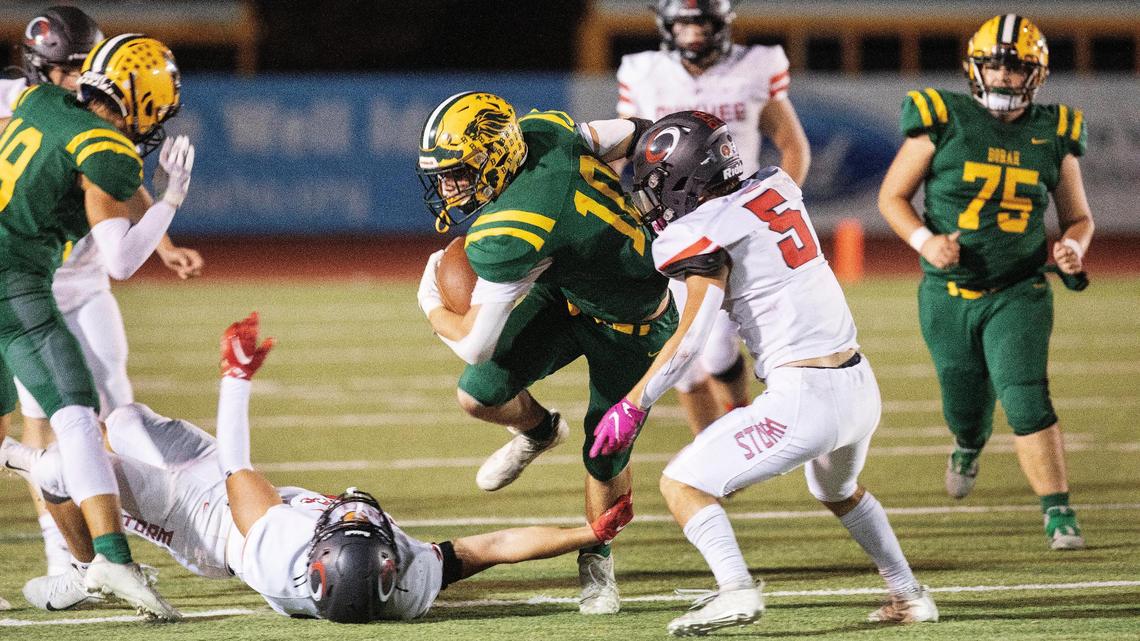 Borah’s Parker Rushton plows through the Owyhee defense last fall at Dona Larsen Park. Rushton returns for his senior year after leading the 5A classification with 1,227 yards last season.