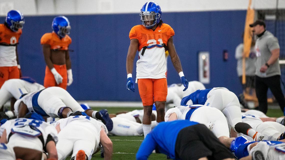 Boise State safety Tyreque Jones enjoys a taste of victory watching the Broncos offense do push-ups after losing a team-building contest at spring camp in the Caven-Williams Sports Complex.