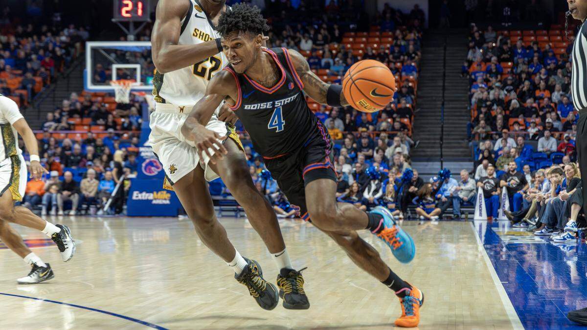 Boise State guard Dylan Andrews drives on Wichita State forward Noah Hill in the first half at ExtraMile Arena in Boise, Tuesday, Nov. 18, 2025.