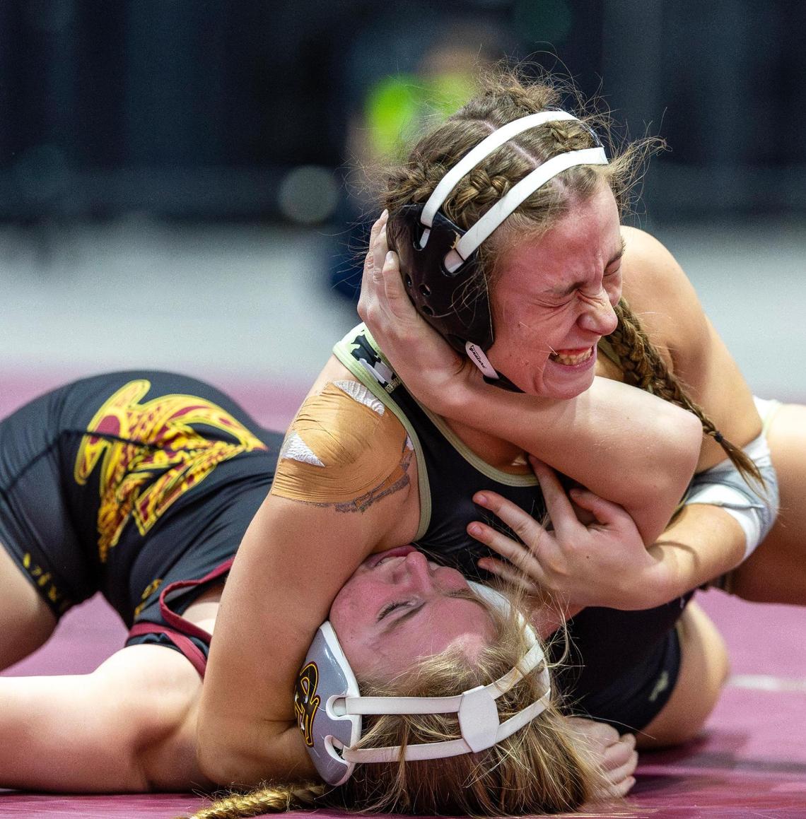 Kuna senior Zoe Fries, top, enters the wrestling state tournament undefeated at 38-0 and as the top seed in the girls’ 138-pound division.