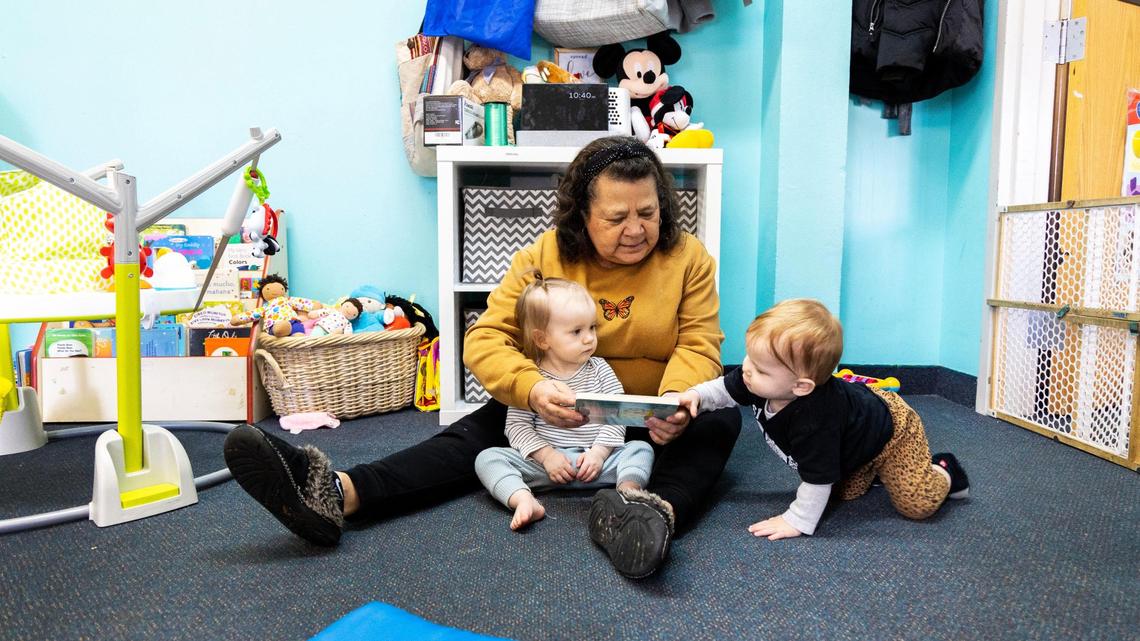 Dora Rodriguez reads to two children less than one years old at Giraffe Laugh 2, a childcare center in Boise that serves kids from six weeks old to age five, Tuesday, March 7, 2023.