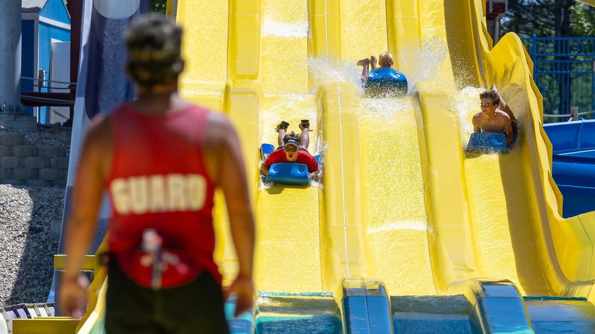 A lifeguard watches as people use a waterslide at Roaring Springs Waterpark in Meridian. Several bullets ricocheted into the facility last summer during a police shooting on Interstate 84.