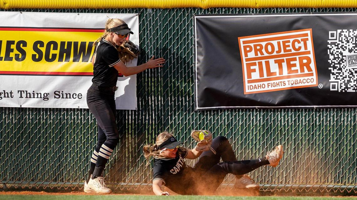Capital senior Kharson Castell crashes into the fence while making a catch Thursday.