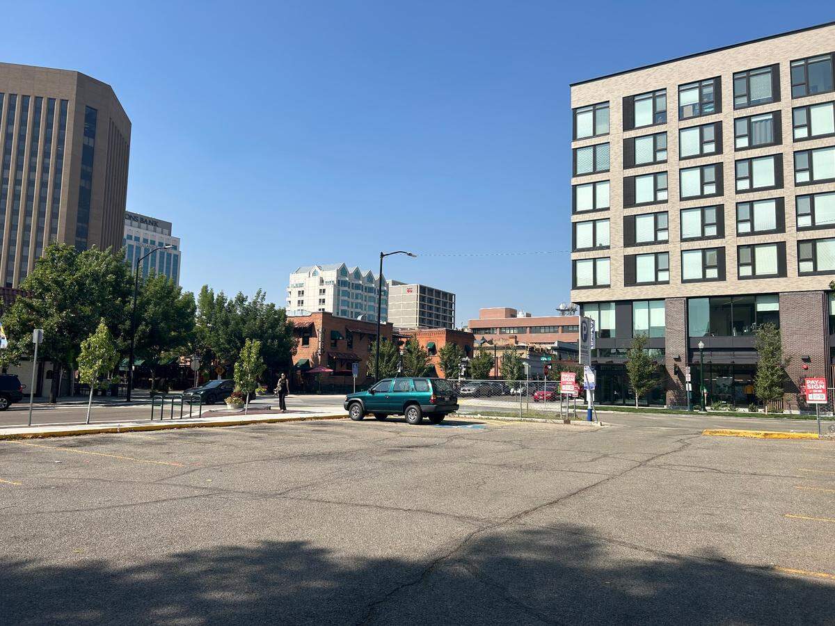 Boise’s urban renewal agency, Capital City Development Corp., greenlit next steps for Grove Street upgrades on Aug. 14, including a removing this public parking lot for a multicultural public space across from the Basque Block at 521 W. Grove St. The U.S. Bank Plaza is on the left and the Thomas Logan Apartments are on the right in this view looking north.