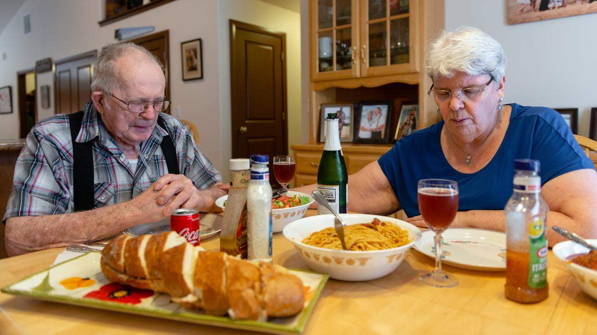 Delmar Scroughams and his wife, Vergie “Verg” Scroughams, pray before dinner on May 1, 2018. Delmar developed dementia after a stroke in 2009 and recently started displaying anger. “In 45 years of marriage, we’ve never had a big fight,” says Verg. “That’s not my Delmar.”